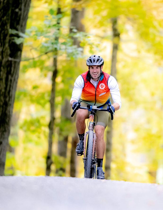 gravel bike rider cresting hill